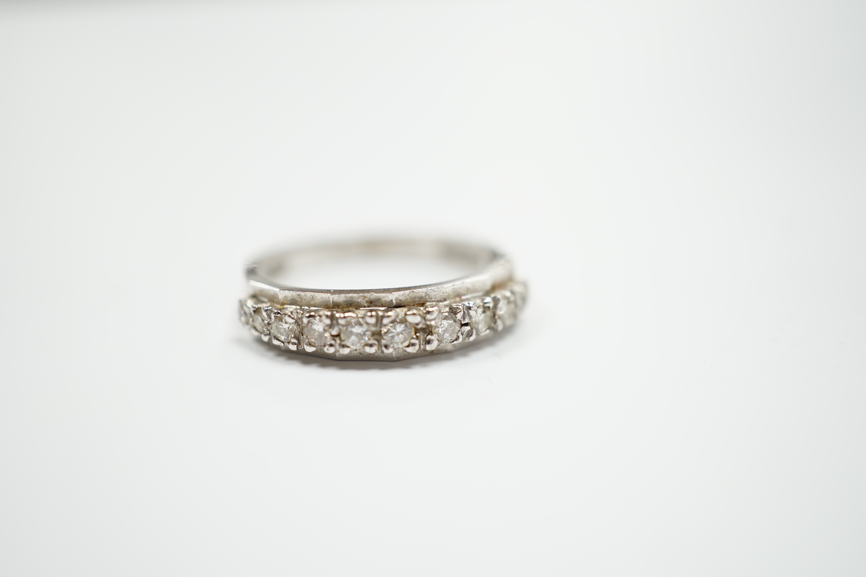 An 18ct white gold and diamond chip set half eternity ring, size M, gross weight 2.8 grams.